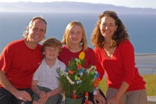 Our Christmas photo in Nelson, New Zealand, picturing our little seedling, which is topped by a cut-out sun because we celebrated the Summer Solstice and decorated the tree on the same day: December 21, 2009.